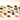 An assortment of various chocolates and truffles, including squares, domes, and pieces with different coatings, arranged neatly on a light surface.